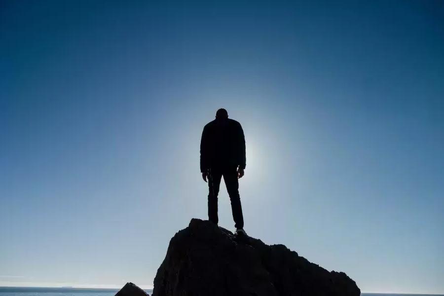 尼克Whittlesey standing on a rock.